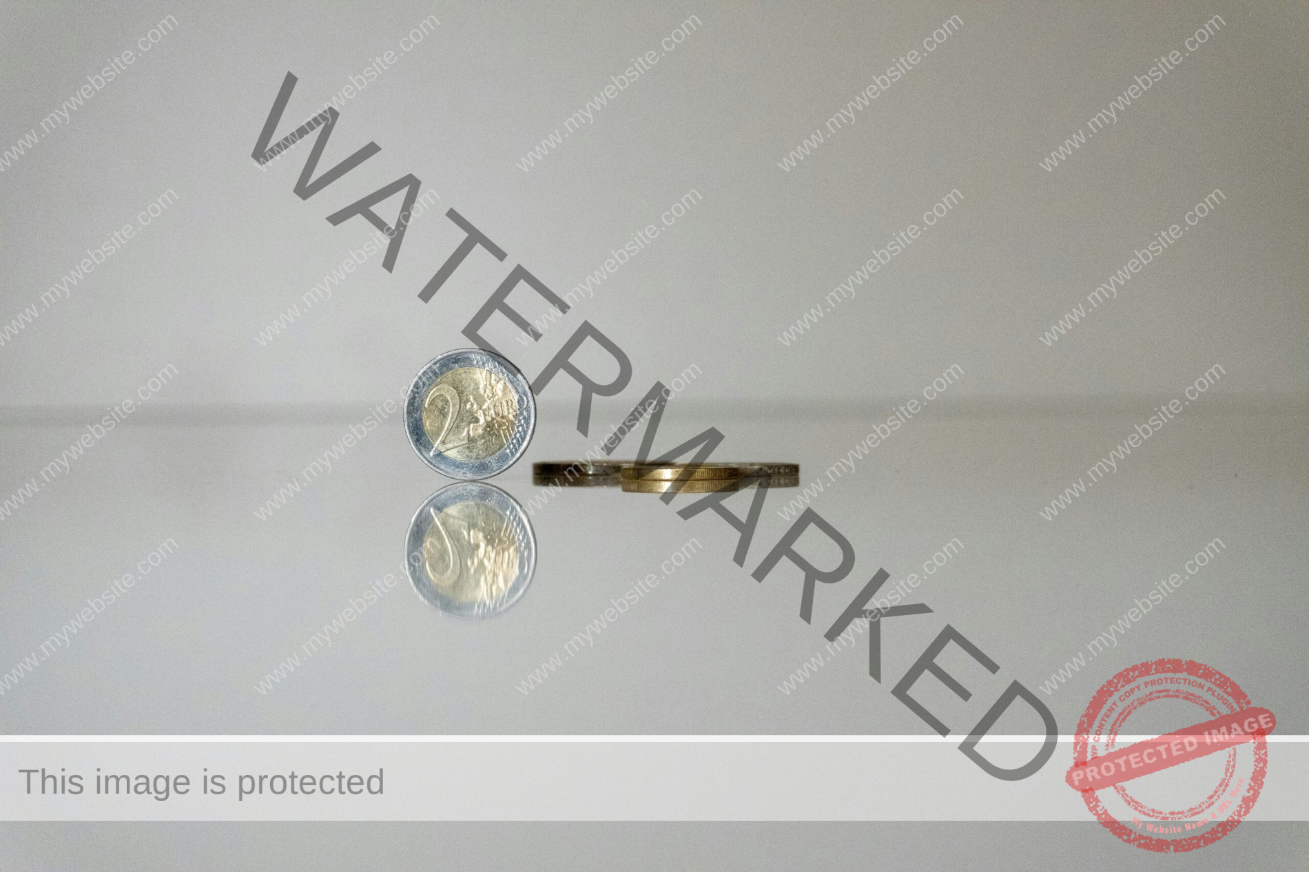 a gold ring with a coin on top of it